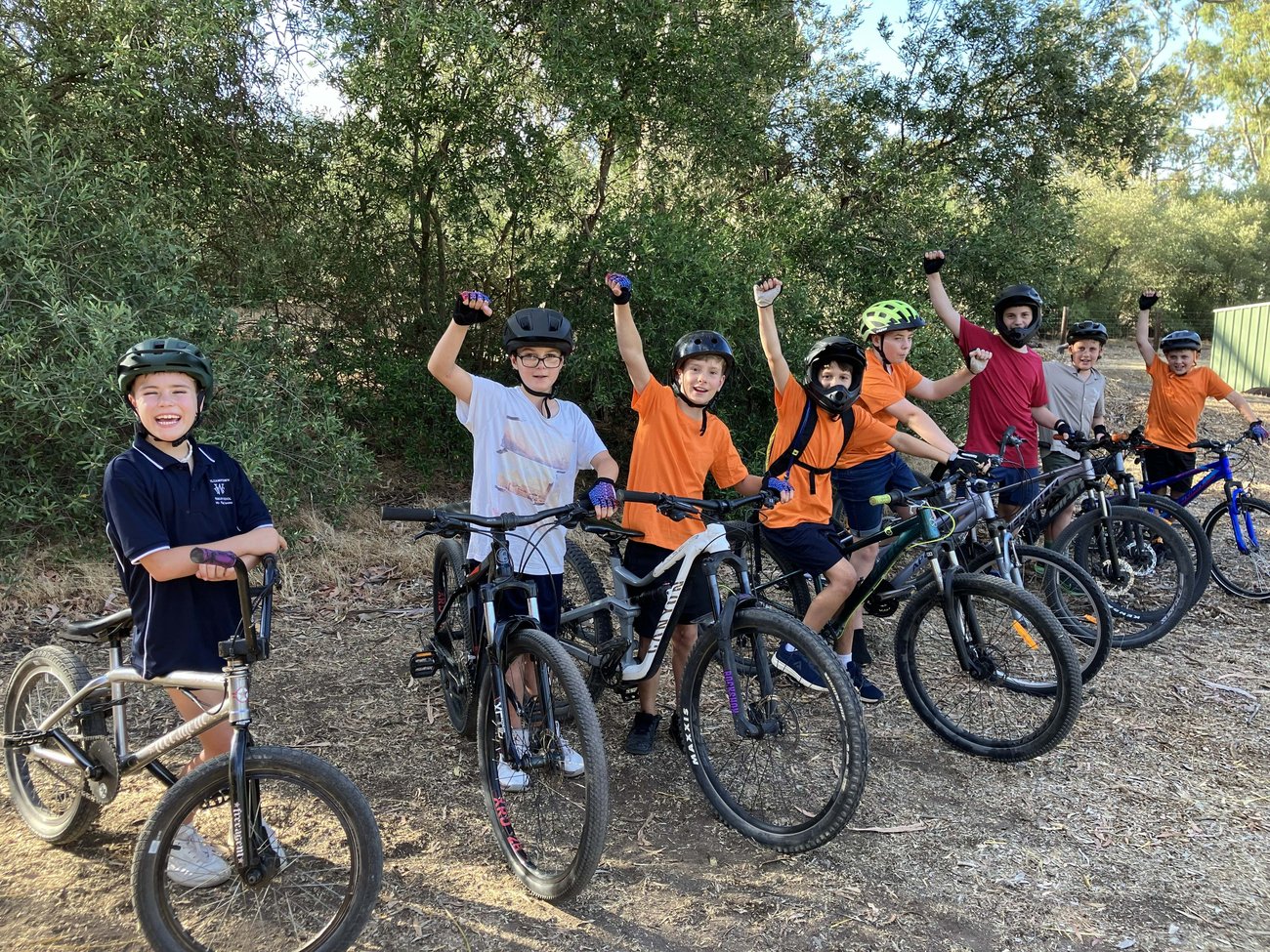 kids on bikes waving